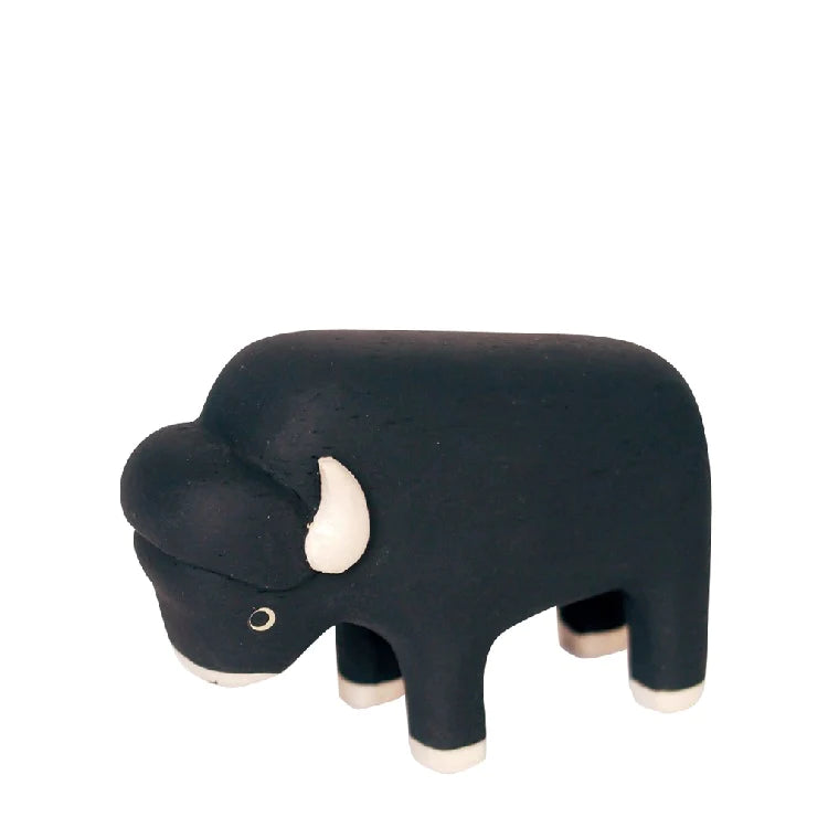 A simple hand-carved Handmade Tiny Wooden Bison with white accents on its horns and hooves, against a plain white background.