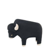 A small, black Handmade Tiny Wooden Bison figurine with prominent white horns and hooves, isolated on a white background.