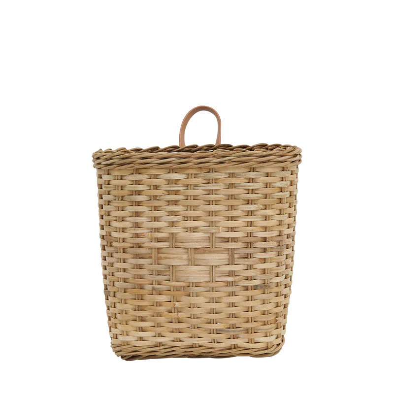 The Rattan Bowery Basket is a storage essential made from natural light brown rattan, featuring a lid and curved handle. It’s elegantly presented against a plain white background, adding charm to any wall decor.