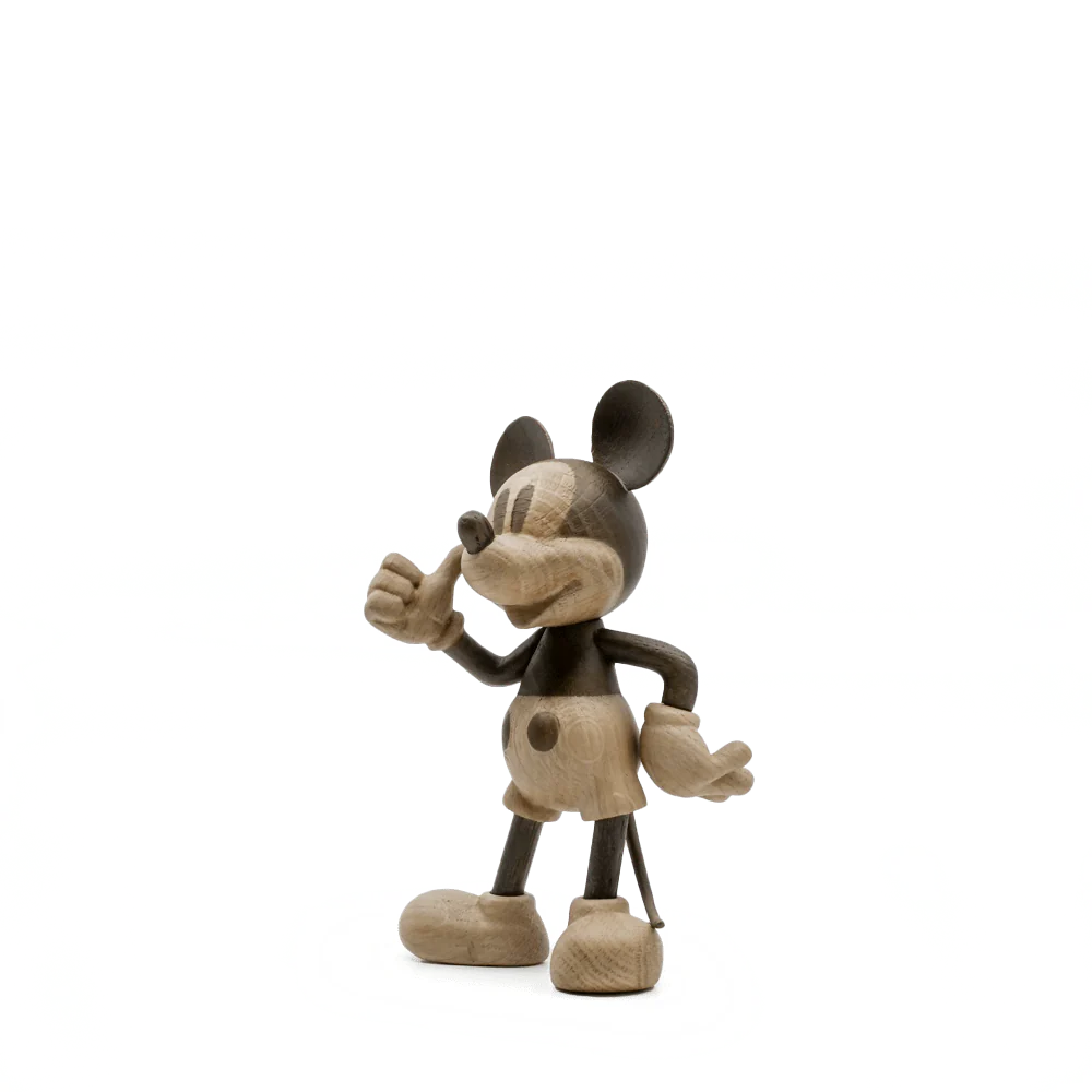 The "Mickey Mouse, Oak" is a wooden figurine capturing the adventurous essence of a famous cartoon mouse, featuring exaggerated ears, shorts, large shoes, and a thumbs-up pose in a natural wood finish.