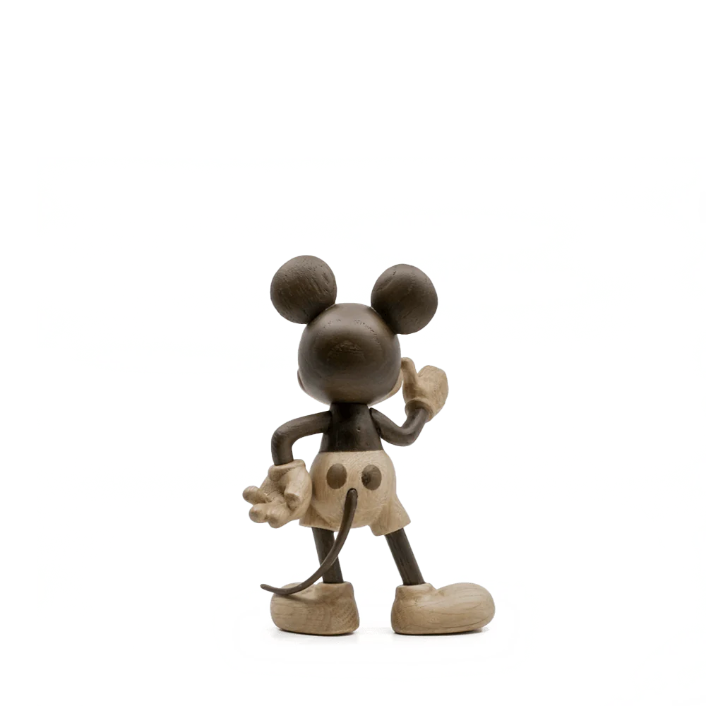 The "Mickey Mouse, Oak" sculpture embodies an adventurous spirit, standing with a hand on its hip and the other raised. It showcases a neutral beige and brown color palette with abstract textures and rounded forms.