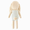 The Cuddle + Kind Briar the Bunny - Light Blue is a hand-knit, 100% cotton bunny doll from Peru, featuring long floppy ears, a fluffy pom-pom tail, and a light blue romper, shown from the back.