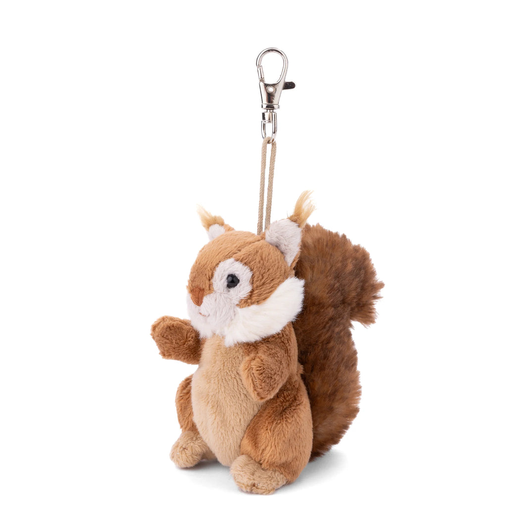 The Bukowski - Brunis Squirrel Bag Charm features a plush squirrel design complete with a fluffy brown tail, soft white cheeks, and a convenient metal clip on top for easy attachment. This adorable woodland companion is the perfect cute keychain or bag charm for your favorite bag or backpack.