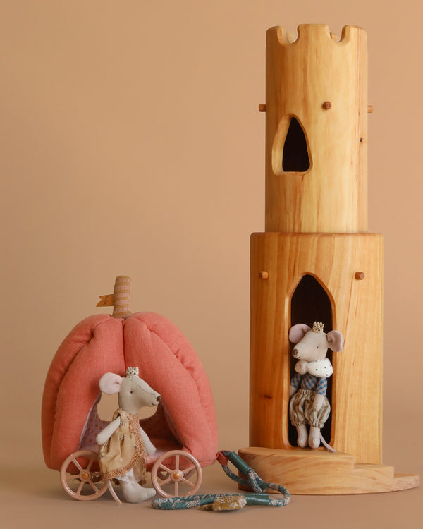 The Ostheimer Wooden Tower & Maileg Royal Mouse Set features two regal felt mice in a fairy-tale scene, with one riding a pink pumpkin carriage and the other in a wooden tower, all displayed on a beige background.