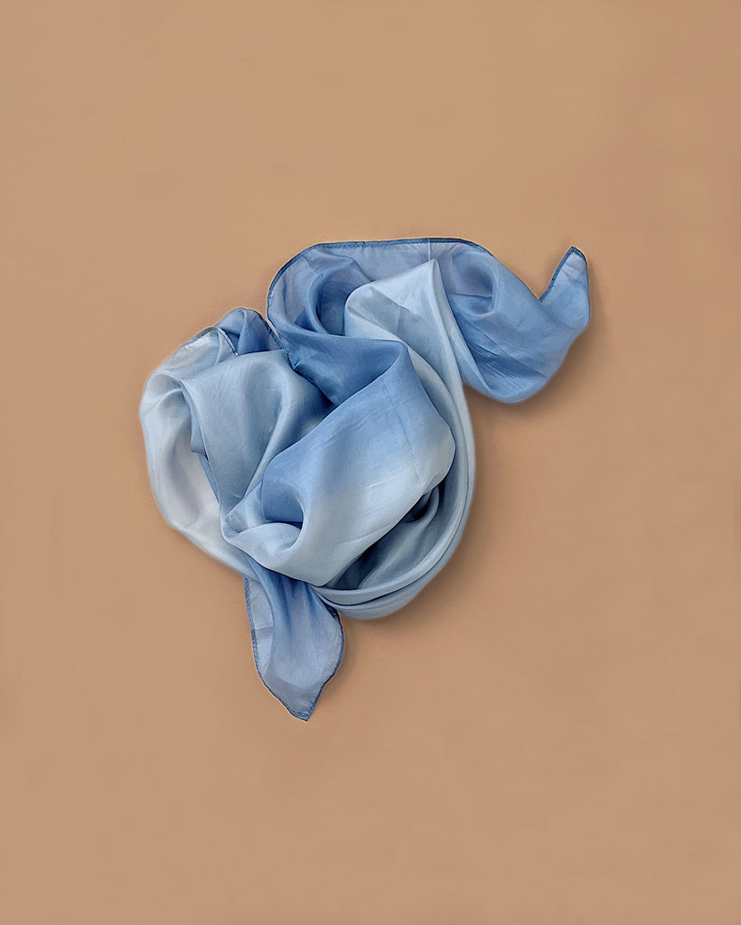Sarah's Silks Earth Playsilk - Stone, crafted from 100% pure silk with a stone-inspired gradient, is loosely arranged on a plain beige background—ideal for open-ended play.