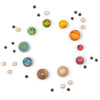 Assorted colorful Grapat Dear Universe planets and candies arranged in a circular pattern on a white background, simulating a solar system layout with small round candies as stars.