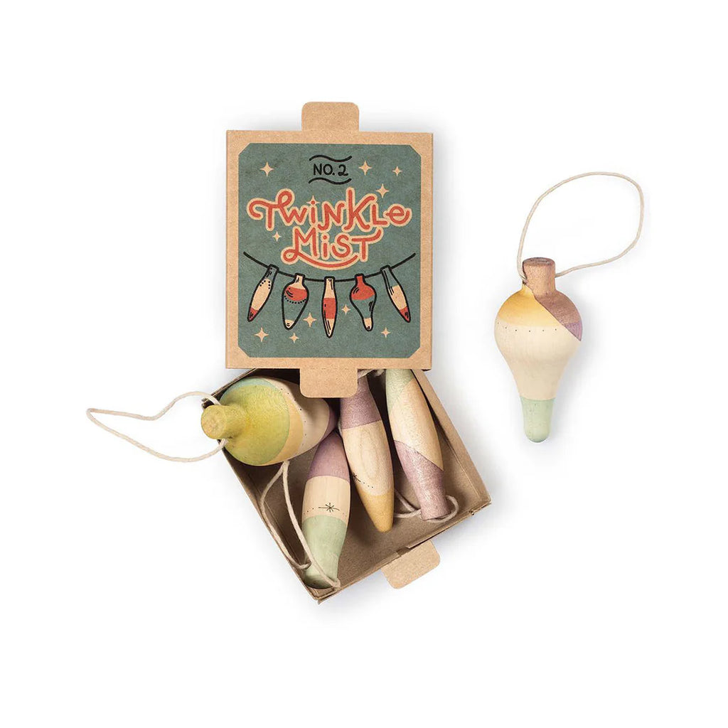 The Grapat Ornament Set - Twinkle Mist includes four pastel spinning tops, ideal as ornaments or holiday decor. An additional spinning top with a string is displayed next to the open box.