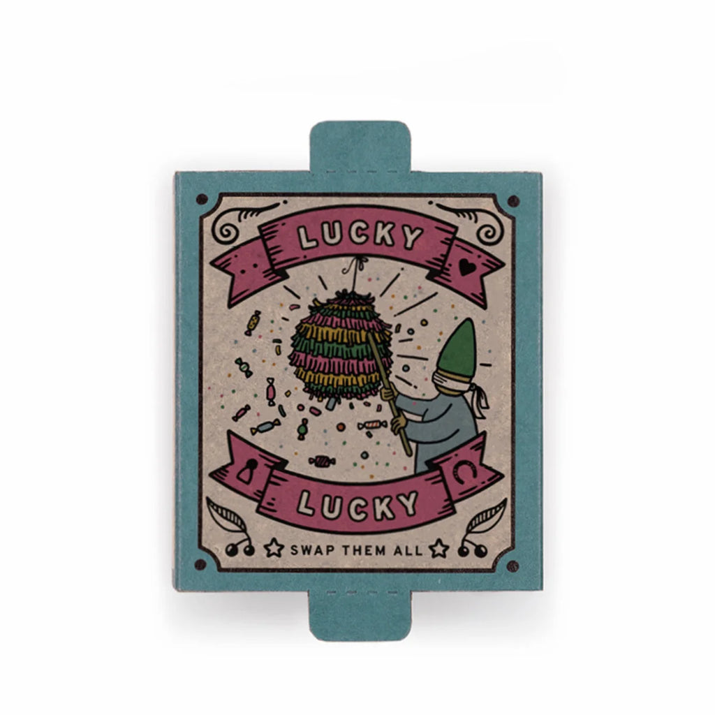 A vibrant card from the Grapat Lucky Lucky Surprise Set 5th Edition features a gnome striking a colorful piñata amidst scattered candies. The teal background showcases the phrases “LUCKY LUCKY” at the top and bottom, with “SWAP THEM ALL” highlighted at the bottom center—making it an ideal addition to any collectible toys or surprise box set collection.