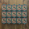 Twelve boxes of the Grapat Lucky Lucky Surprise Set 5th Edition—each featuring a charming bee illustration—are arranged in three rows on a wooden surface, inviting discovery of collectible toys and delightful mystery treasures inside.