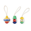 Three hand-painted wooden ornaments from the Grapat Ornament Set - No 9 - Pure Shine, each with unique shapes and geometric patterns in red, blue, green, and yellow, arranged side by side with string loops on a white background.