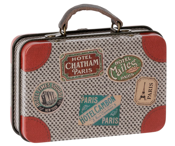 The Maileg Suitcase, Small is a charming vintage-inspired piece adorned with travel stickers from Paris and New York, red leather corners, and a textured pattern. Perfect for storing gifts or carrying small soft toys, this suitcase captures the whimsical style of Maileg’s iconic metal suitcases—an enchanting addition to any collection.