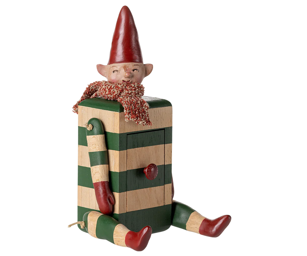 The PRE-ORDER: Maileg Elf with Drawer - Green (Estimated Arrival Mid August) features a whimsical elf in red accessories sitting on a striped box body with moveable limbs and a small drawer on its torso.