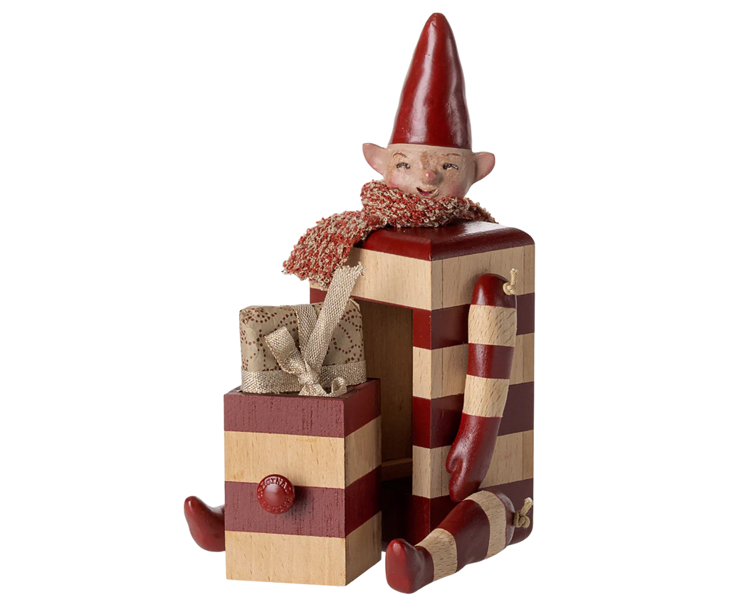 The PRE-ORDER: Maileg Elf with Drawer - Red features a smiling, blocky elf in red-and-beige stripes with a pointed hat and scarf, sitting beside a matching ribbon-tied gift box. Estimated arrival is mid August.