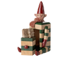 PRE-ORDER the Maileg Elf with Drawer - Green (estimated arrival mid August), a collectible elf with a red hat and scarf sitting on green and beige striped blocks, featuring striped arms and legs, plus a small gift box in front.