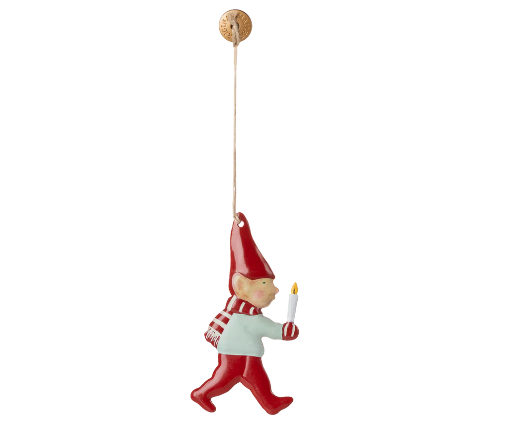 The Maileg Metal Ornament - Pixy, Candle Light features a hand-painted gnome in a red hat, scarf, and pants holding a white candle, hanging by a string—perfect for adding festive charm to your Christmas tree.