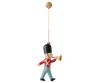 The Maileg Metal Ornament, Guard - Trumpet features a hand-painted toy soldier in a red jacket, blue pants, and black hat blowing a gold trumpet, perfect for your Christmas tree. Easily hangs by a string from a small round hook.