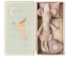 The Maileg Tooth Fairy Mouse, Little Sister, dressed as a tooth fairy, lies in a matchbox bed next to a purple heart-shaped tooth box with an illustrated mouse fairy and "Dream & Tooth Fairy" on the lid.
