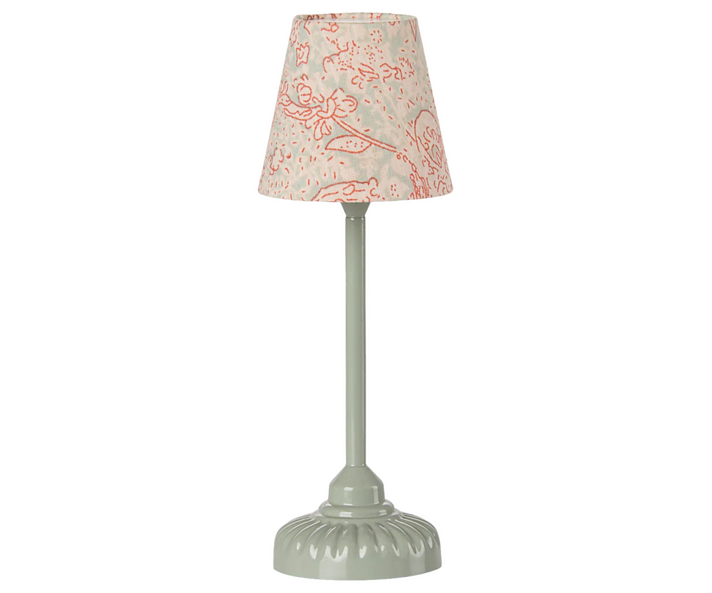 The Maileg Fully Furnished SuitCasa Set includes a charming table lamp with a pale green base and cream lampshade with pink flowers—perfect for brightening any mouse house or enhancing your Maileg SuitCasa display.