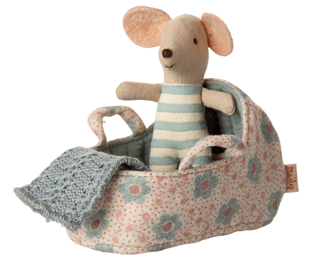 The PRE-ORDER: Carry Cot, Baby Mouse Size - Blue (ships late November) features a small stuffed mouse in blue-and-white stripes, nestled in a floral-patterned cot with a blue knitted blanket—a charming sleep solution for baby mice.