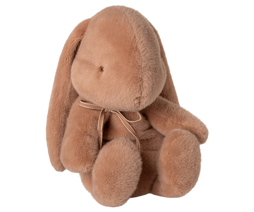 The Maileg Plush Bunny, Medium - Vintage Rose features long floppy ears, a round body, and a small bow around its neck. Sitting upright against a white background, this soft toy is perfect for cuddling and comfort.