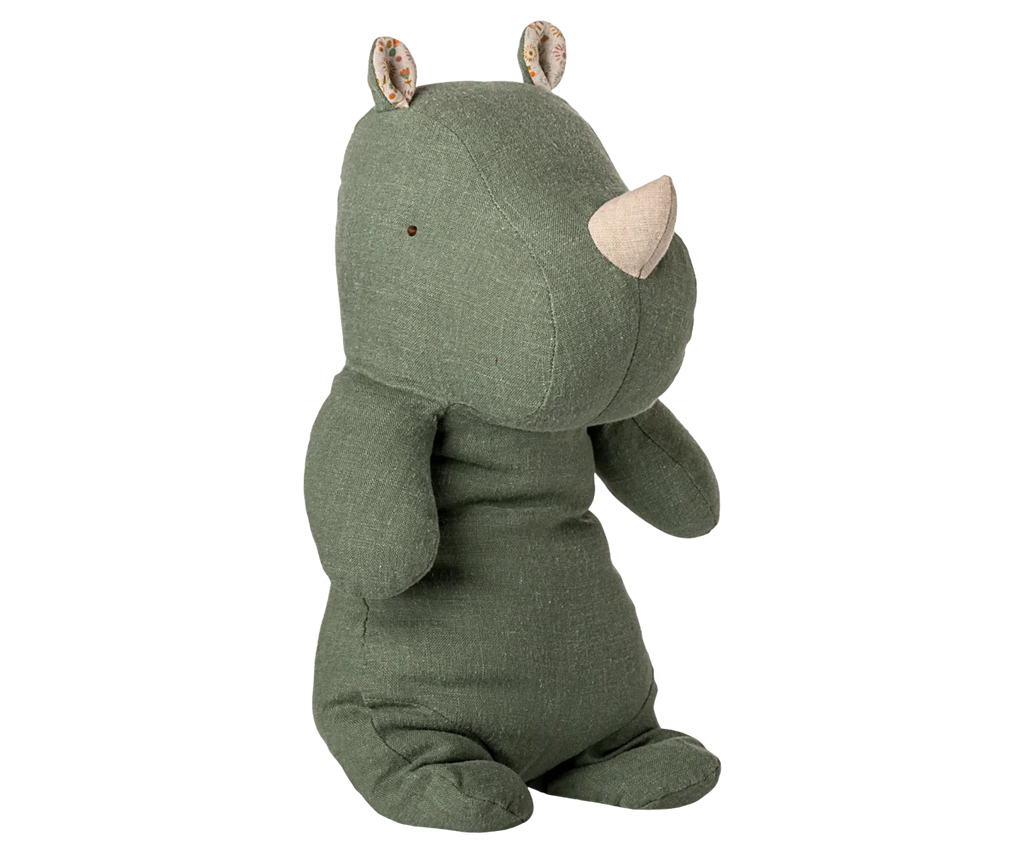 The Maileg Rhino, Medium - Sage is a plush toy in green with soft fabric, a beige horn, small button eyes, and patterned inner ears, shown sitting upright against a plain white background.