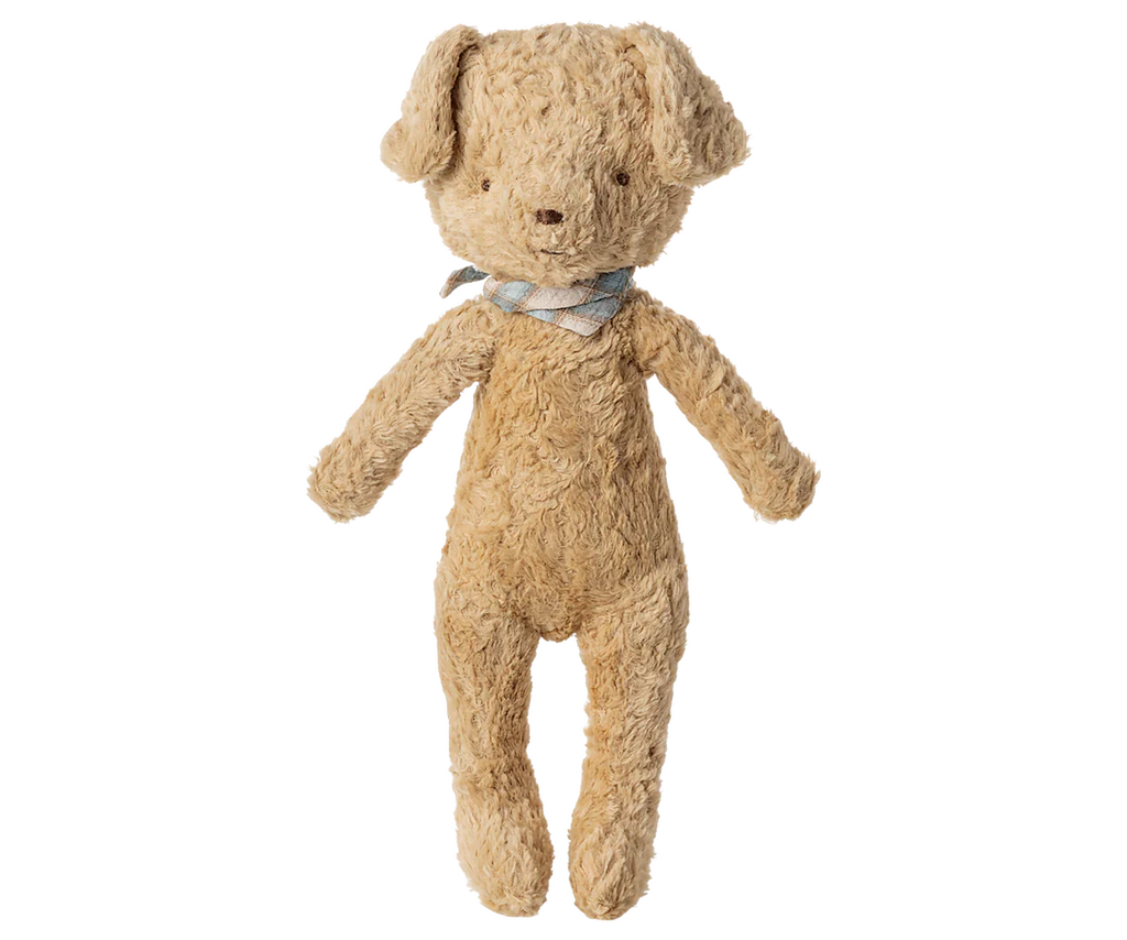 A Maileg Poodle Dog, Vintage Plush in soft sand with floppy ears and cotton viscose fur, stands upright against a plain background, featuring a charming blue-and-white checkered bow around its neck.