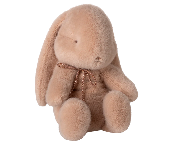 The Maileg Plush Bunny, Small - Powder, is a soft light brown stuffed animal with long floppy ears, a simple face, and a thin twisted cord bow around its neck, shown sitting upright against a plain white background.