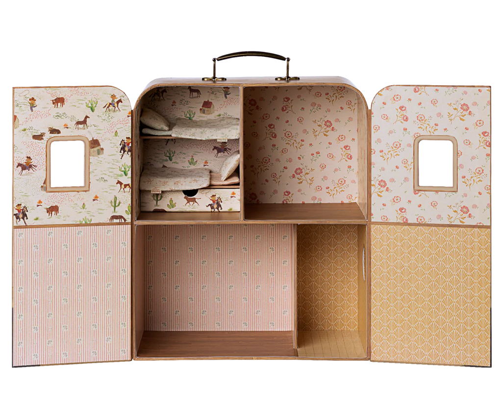 The Maileg Fully Furnished Christmas Suitcasa with Royal Twins is a decorative cardboard suitcase with a handle, featuring four pastel-lined compartments for Maileg mice and shelves displaying doll-sized bedding with cute animal designs.