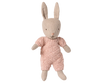 A beige fabric bunny doll wears the Maileg Extra Clothing: Knitted Suit, Micro - Rose—a pink knitted outfit for Micro Bunny—featuring long upright ears and a simple embroidered face, set against a plain white background.