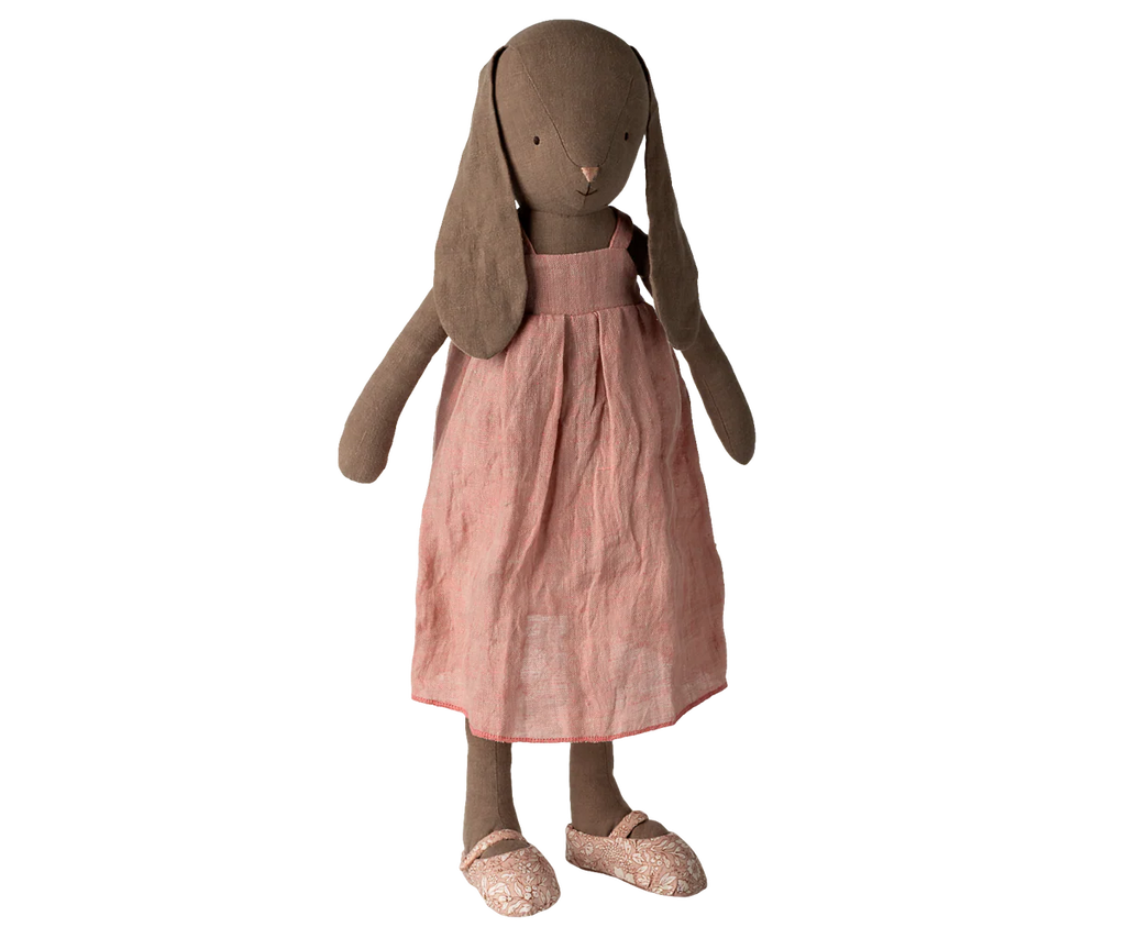 The Maileg Bunny, Size 4 - Brown, wearing a pink dress and matching shoes, stands upright against a plain white background.