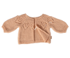 The Maileg Knitted Cardigan, Size 4 in Light Rose (expected 02/15/26), features a decorative leaf pattern on the shoulders and loose-fit sleeves, ideal for bunny clothes fans. Displayed on a plain white background.