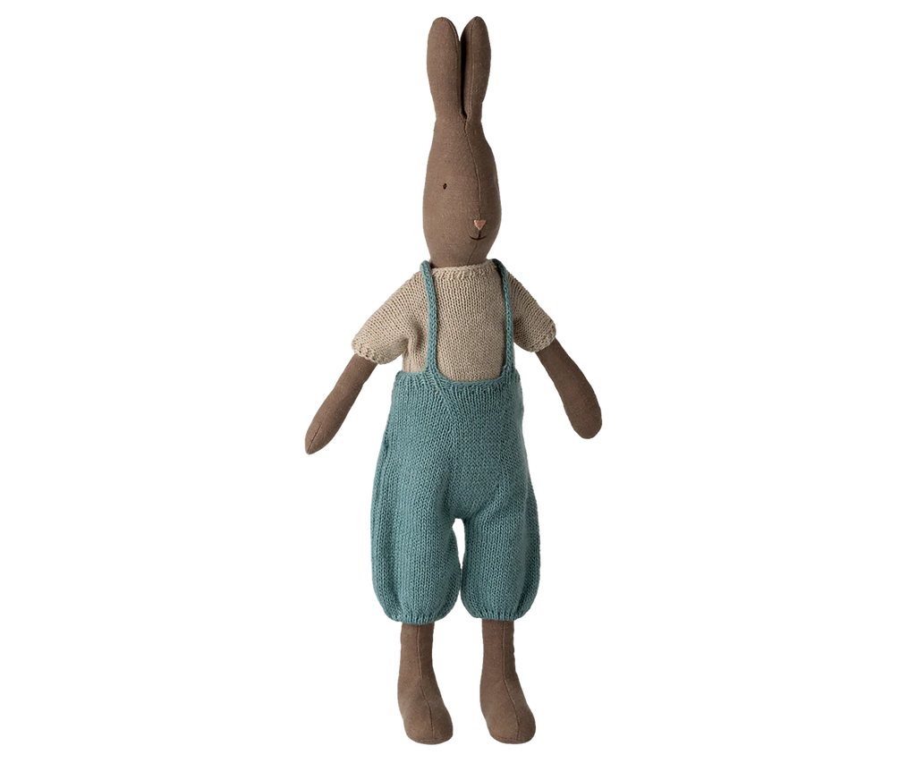 The Maileg Rabbit, Size 3 - Brown, wears a knitted shirt and overall, and stands upright against a plain white background.