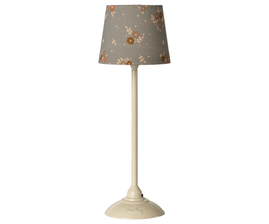 The Maileg Floor Lamp, Miniature - Sand, features a cream color and a slim base with a gray shade adorned with orange, white, and brown florals—ideal for adding charm to any dollhouse. Expected arrival: 03/15/26.