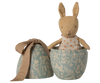 The Maileg Easter Egg with Micro Rabbit, Small - Dusty Blue features a soft rabbit doll in a polka dot dress inside a decorative blue metal egg box with botanical patterns—a delightful gift for children. Expected arrival: 02/15/26.