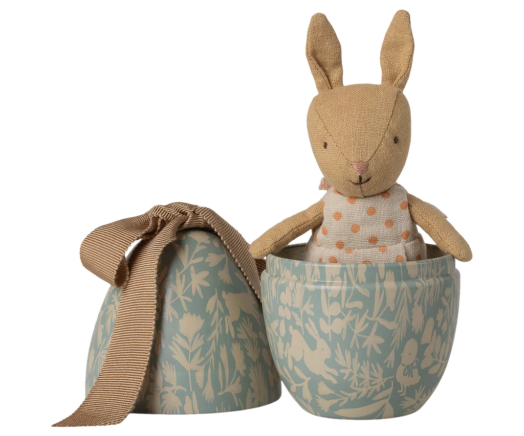 The Maileg Easter Egg with Micro Rabbit, Small - Dusty Blue features a soft rabbit doll in a polka dot dress inside a decorative blue metal egg box with botanical patterns—a delightful gift for children. Expected arrival: 02/15/26.