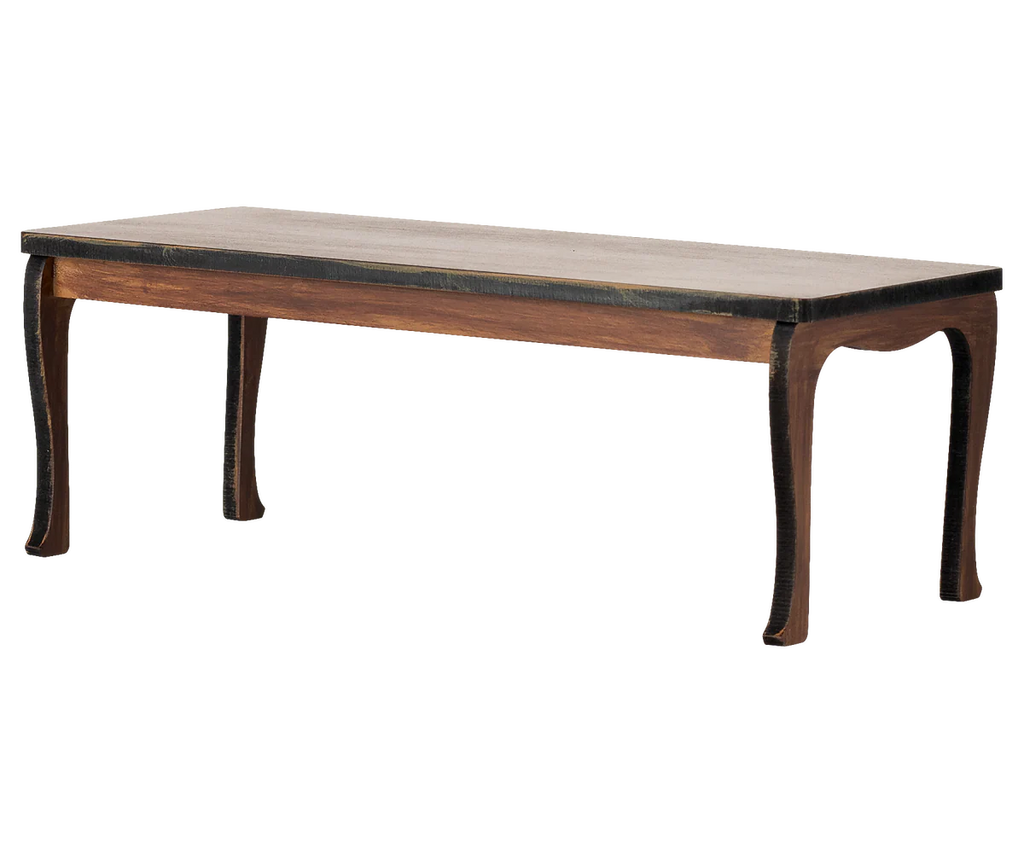 The Maileg Long Dining Table, Mouse features a rectangular wooden design with gently curved legs and a dark brown finish, ideal for mouse furniture or dollhouse accessories. Expected arrival: 03/15/26. Shown against a plain white background.