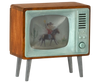 The Maileg Television, Mouse (expected 03/15/26) is a small, vintage-style wooden toy TV with metal legs and a green screen showing a cowboy on horseback. "Analog" appears near the speaker, making it perfect for miniature home decor.