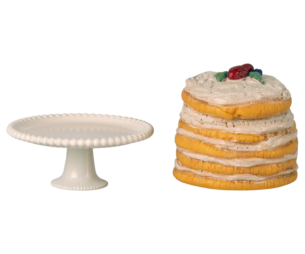 The Maileg Party Cake and Cake Stand, Mouse - Off White (expected 05/01/26), is a charming addition for parties, featuring a petite white stand ideal for displaying toy cakes or treats against a clean white background.