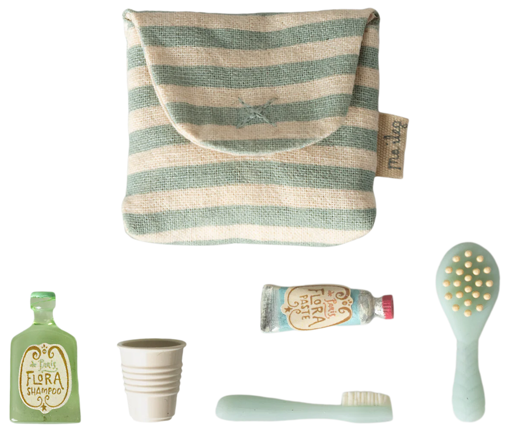 The Maileg Toothbrush Set in Bag, Mouse - Blue Stripe (arriving 04/15/26) includes a small green and white striped pouch with five mini toiletry essentials: shampoo, cup, toothpaste, blue toothbrush, and hairbrush.
