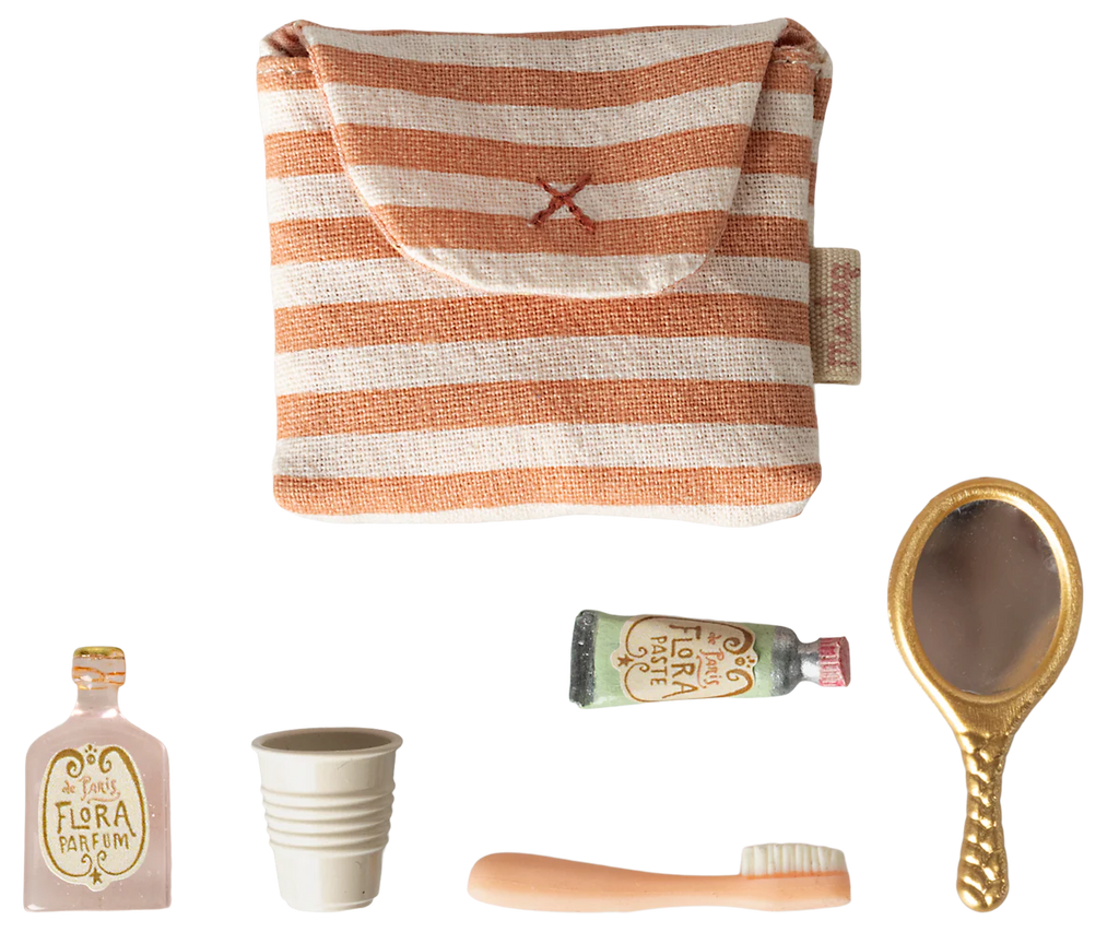 The Maileg Toothbrush Set in Bag, Mouse - Coral Stripe (expected 04/15/26) includes a striped toiletry bag, tiny perfume bottle, white cup, tan hairbrush, "Flora Forte" tube, and gold hand mirror for fun bedtime routine play.
