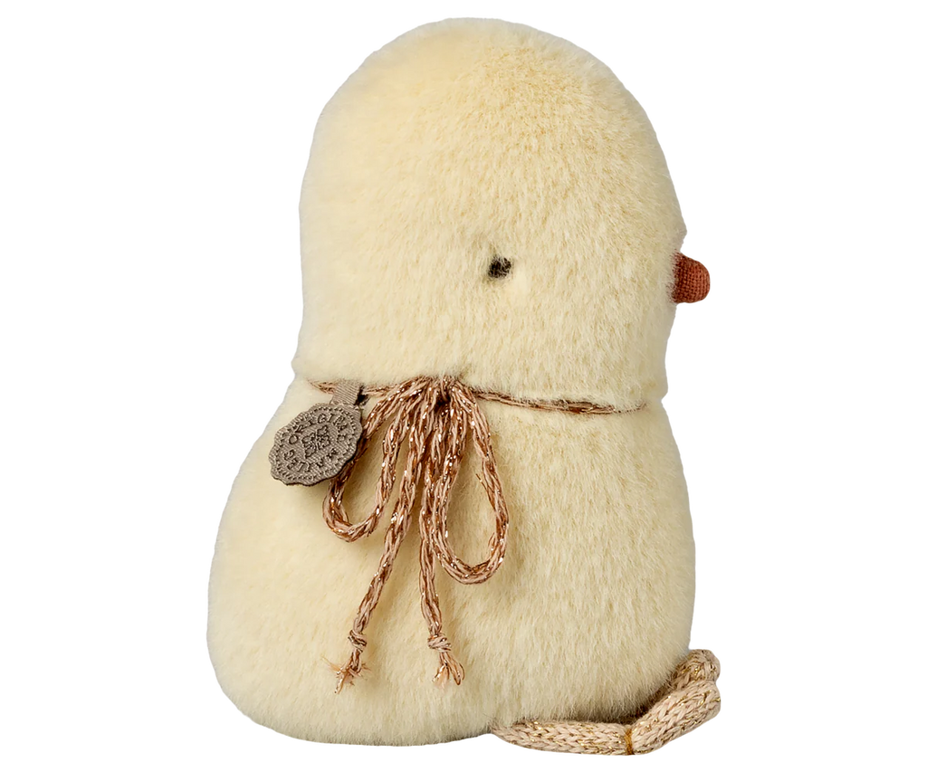 The Maileg Chicken Plush, Mini, features soft yellow fur, a small brown beak, simple dot eyes, and a brown neck string with a decorative tag. This cute stuffed animal is shown from the back.