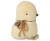 The Maileg Chicken Plush, Mini is a soft yellow stuffed animal with a small brown beak, one stitched eye, a brown string around its neck, and a tag. The plush chicken is shown facing away to display its back.
