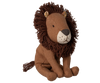Maileg Little Leo the Lion is a small plush with a brown mane, beige face, stitched features, floppy legs, and a visible tail. This adorable stuffed animal sits upright against a plain white background.
