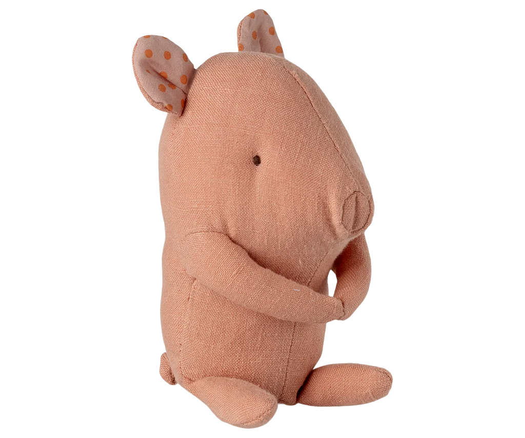 The Maileg Lullaby Friends Pig, Mini - Rose (expected 04/15/26) is a soft pink plush toy with dot-patterned ears, stitched eyes, and curved arms—a charming gift for newborns.