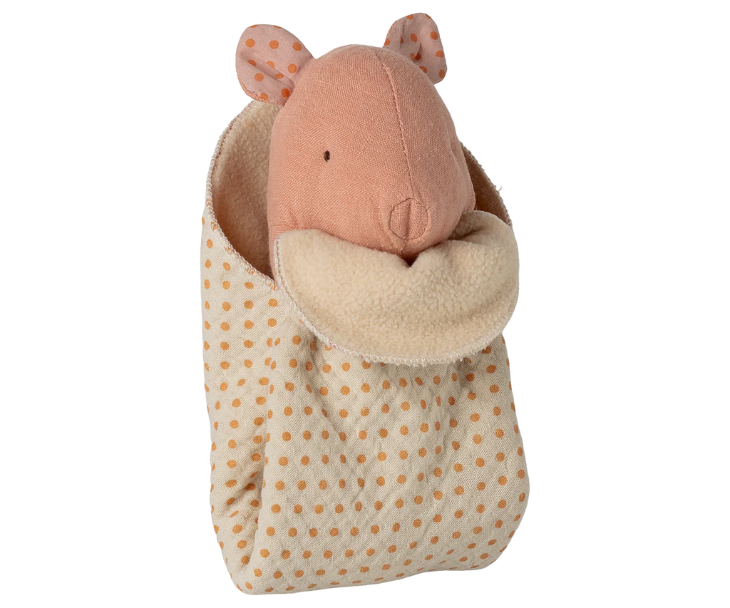 The Maileg Lullaby Friends, Pig, Mini - Rose is a soft pink plush pig with stitched features, wrapped in a cream and orange polka-dot cuddle cloth with fleece lining—perfect as a cozy newborn gift.