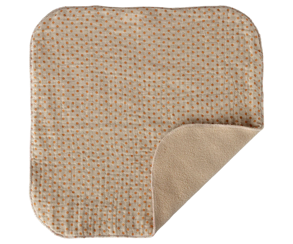 The Maileg Lullaby Friends, Pig, Mini - Rose (expected 04/15/26) features a soft cuddle cloth with orange polka dots on one side and solid beige on the reverse—one corner folded to display both sides, making it a perfect newborn gift.