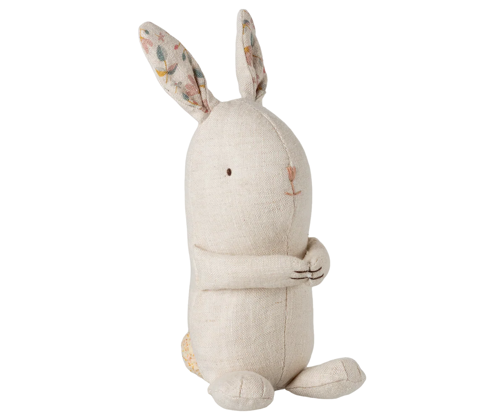 The Maileg Lullaby Friends Bunny, Mini - Nature, is a beige fabric toy with an embroidered face and patterned inner ears, sitting upright—perfect as a newborn gift.