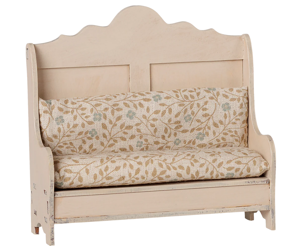 The PRE-ORDER Maileg Kitchen Bench, Mouse - Light Sand (arriving mid September), is a cosy, vintage-style wooden bench featuring a high back, armrests, and a comfy leaf-patterned cushioned seat—perfect for any nook.