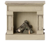 The PRE-ORDER: Maileg Fireplace, Mouse - Off White (arriving mid August) is a small, lightweight wooden fireplace with a vintage finish and decorative logs—ideal for dollhouses or any miniature home display.
