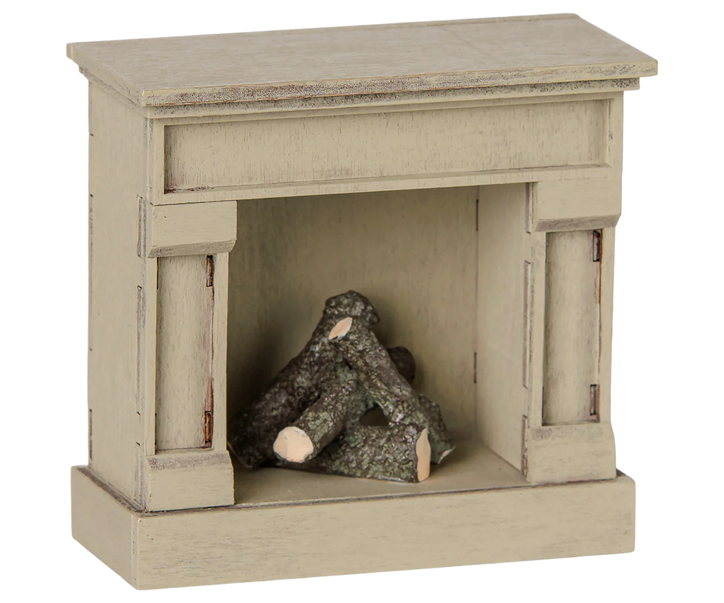 The PRE-ORDER: Maileg Fireplace, Mouse - Off White (Estimated Arrival Mid August) is a small off-white wooden fireplace with a vintage finish, simple mantel, and mini logs—ideal for adding charm to any miniature home.